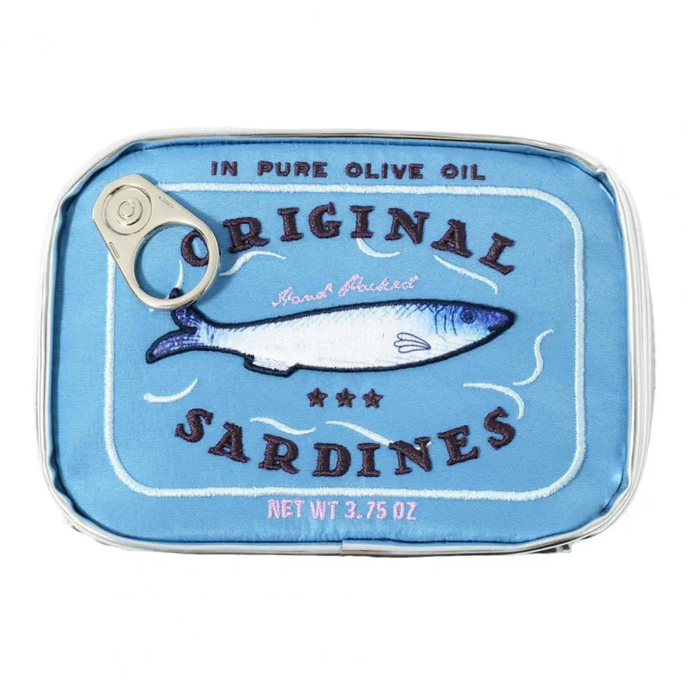 A novelty can-shaped pouch or container designed to look like an open can of 'Original Sardines' in pure olive oil. The front features a light blue background with a printed illustration of a sardine, dark brown text, and a silver metal pull-tab lid on the top left.