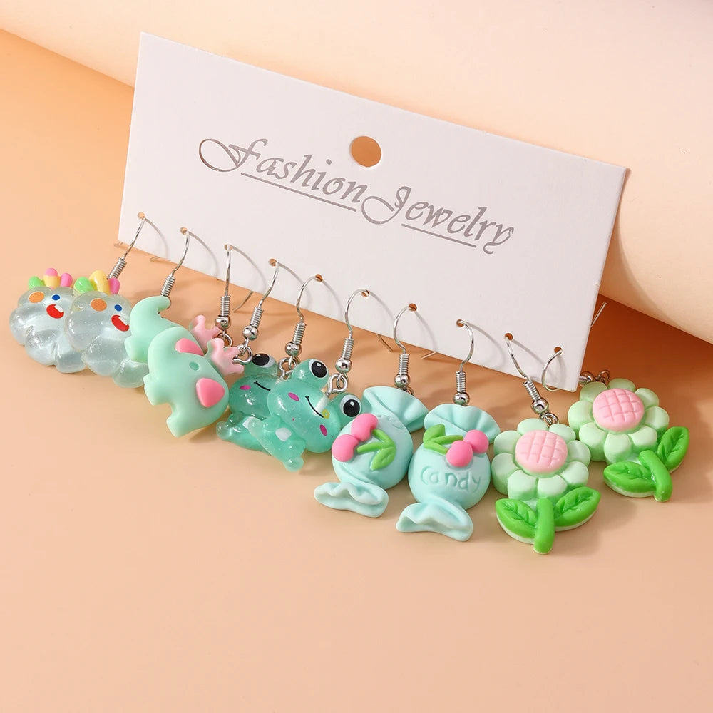 Set of colorful earrings on a 'Fashion Jewelry' card against a beige background