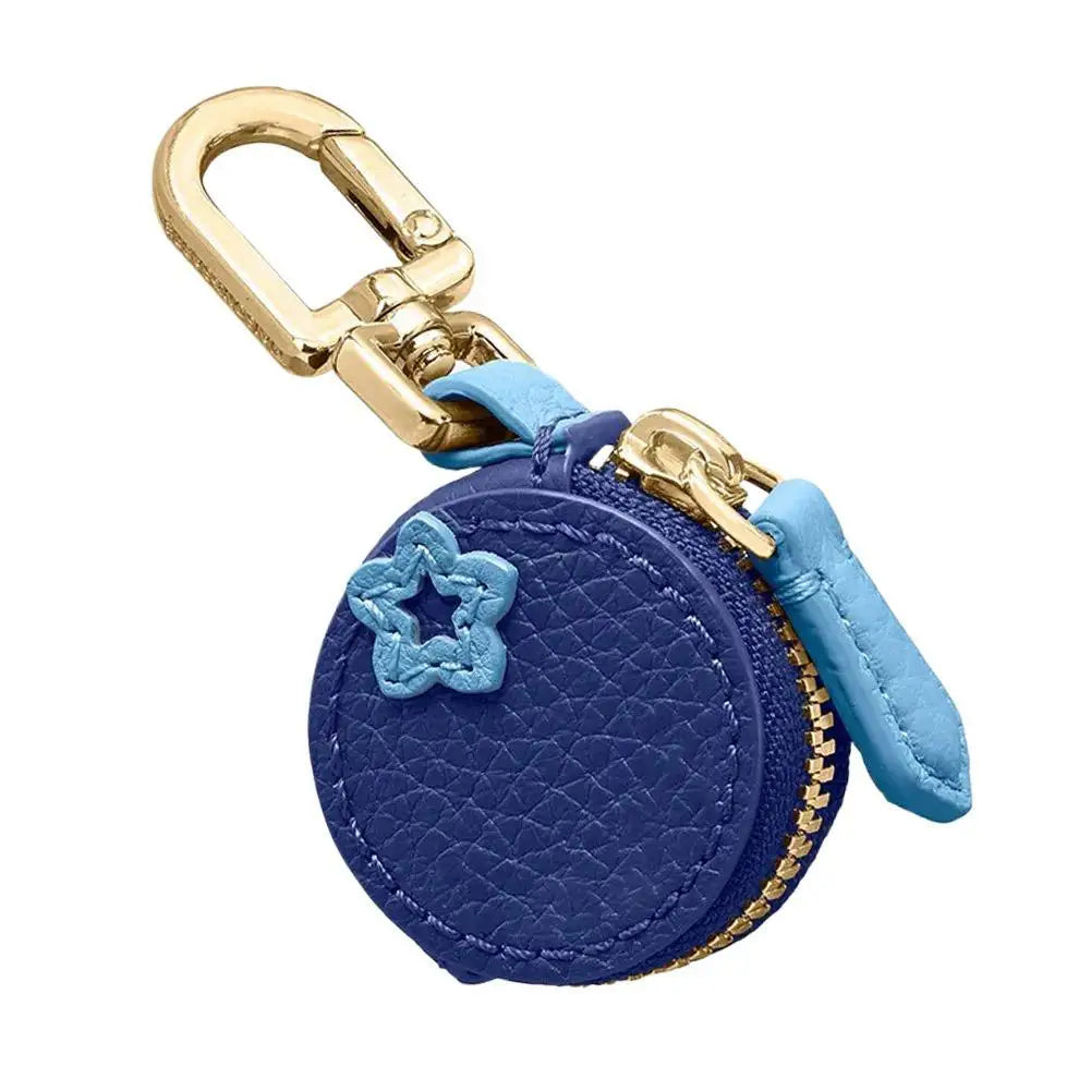 Blue round keychain with gold clasp and star detail on a white background