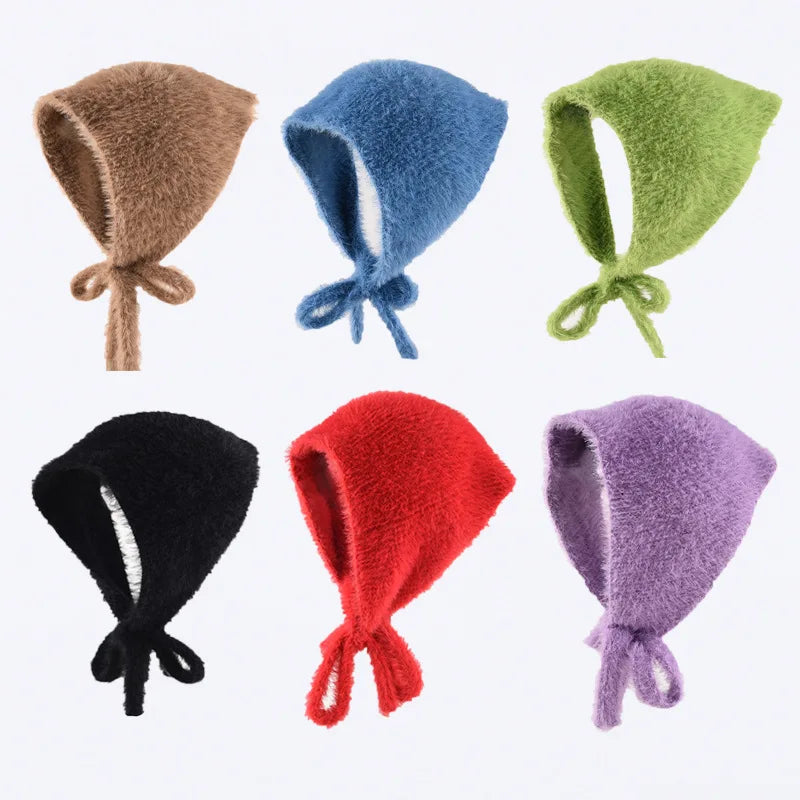 Set of colorful knitted bonnets on a white background