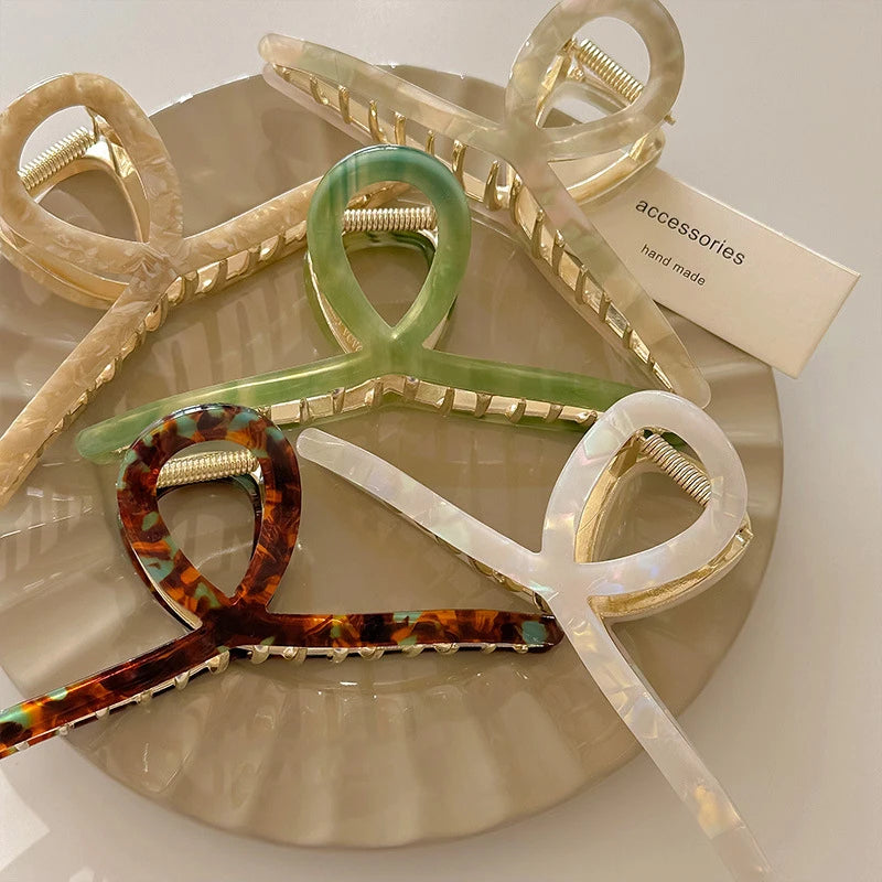 Set of colorful hair clips on a white plate with 'accessories hand made' label.