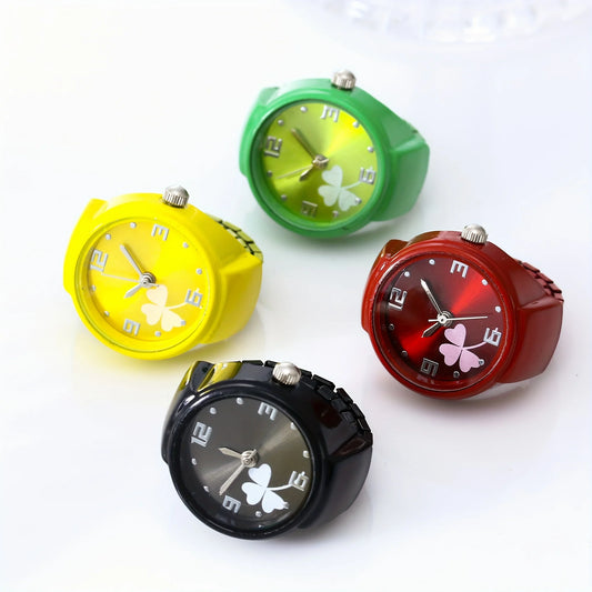 Four analog wristwatches with colorful gradient dials and silicone straps in yellow, green, red, and black, each featuring a clover design on the face.