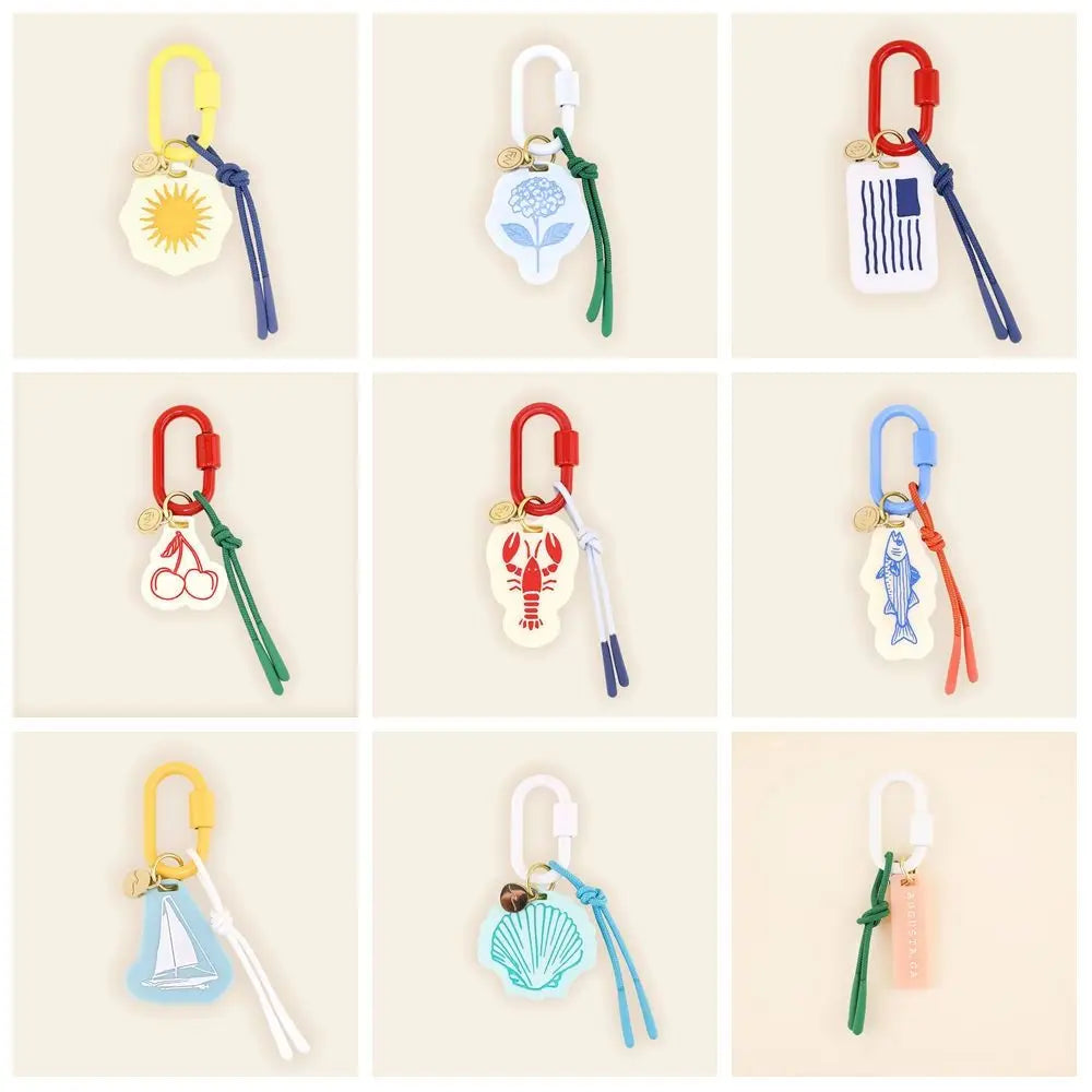 Collection of colorful keychains with various designs on a beige background