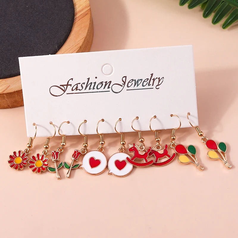 Set of colorful earrings on a 'Fashion Jewelry' card against a beige background