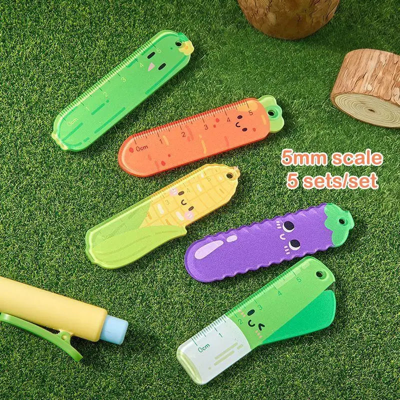Set of colorful cartoon-style rulers on a grass-like surface