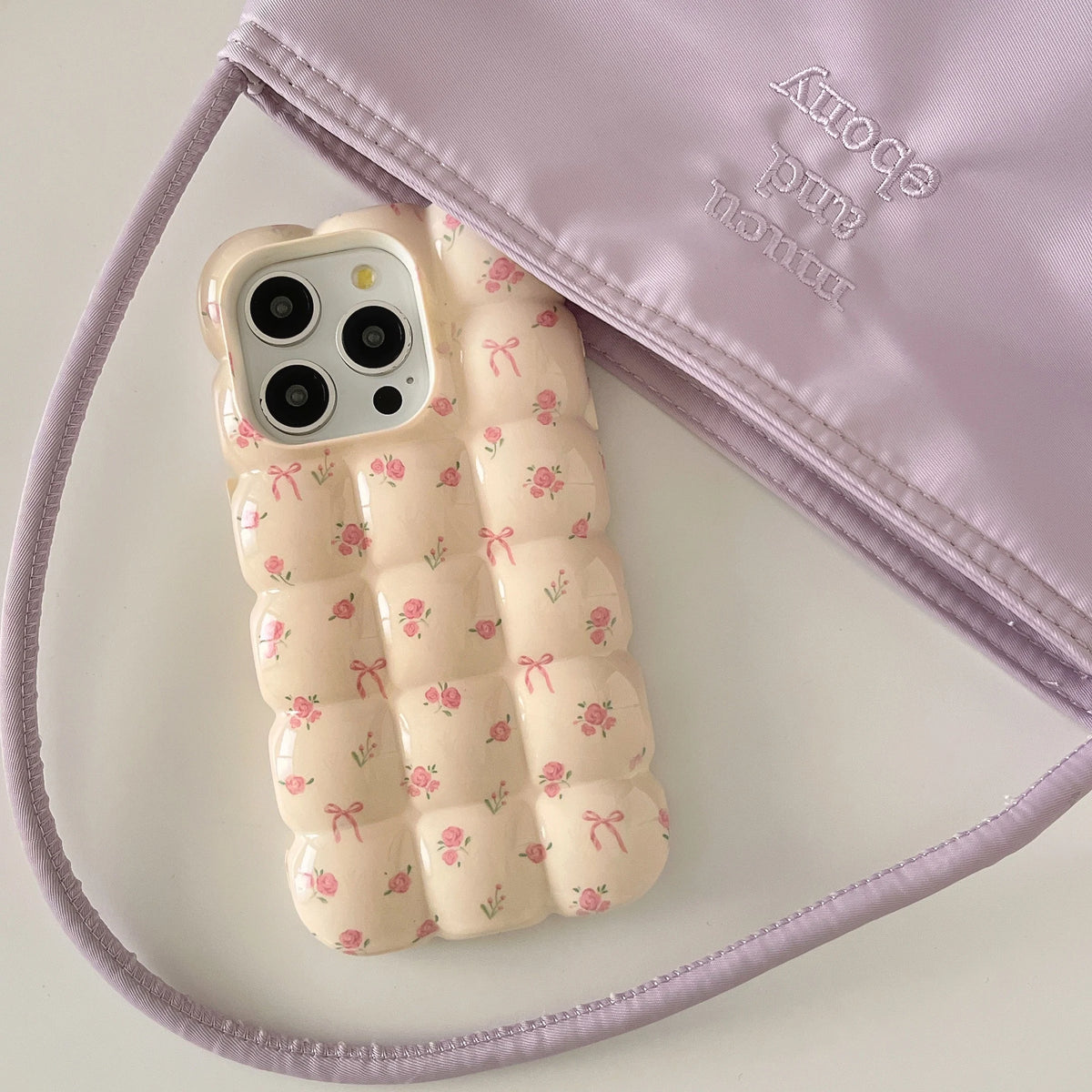Phone case with floral design on a light purple background