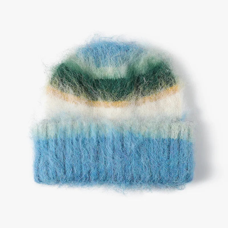 A fuzzy mohair-style knit beanie hat with horizontal stripes of light blue, dark green, cream, and a thin tan stripe, shown on a plain white background.