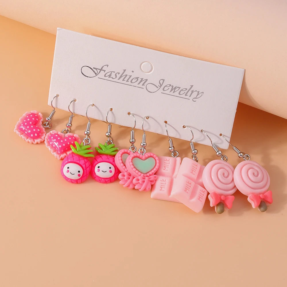 Set of colorful earrings on a 'Fashion Jewelry' card against a beige background