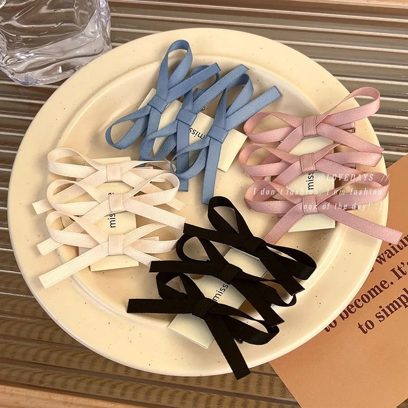 Set of colorful hair ties on a round beige plate with a blurred background.