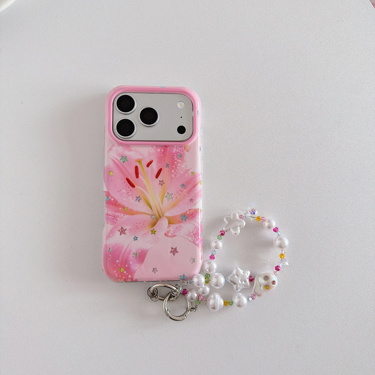 A pink phone case with a lily flower print and glittery star details, attached to a white pearl beaded strap with a silver key ring, shown on a light gray background.