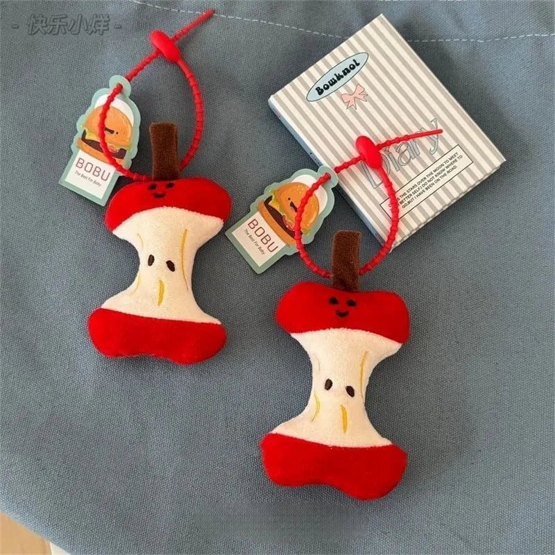Two red and white dog toys shaped like bones with brown ends on a gray background.