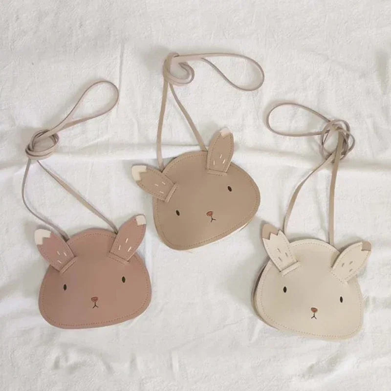 Three small bags shaped like animal faces on a white background