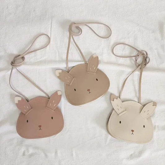 Three small bags shaped like animal faces on a white background
