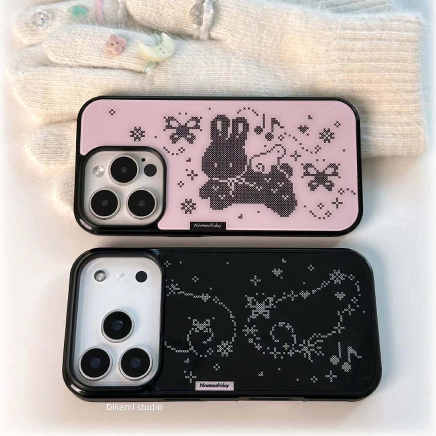 Two phone cases with cartoon character design on a soft fabric background
