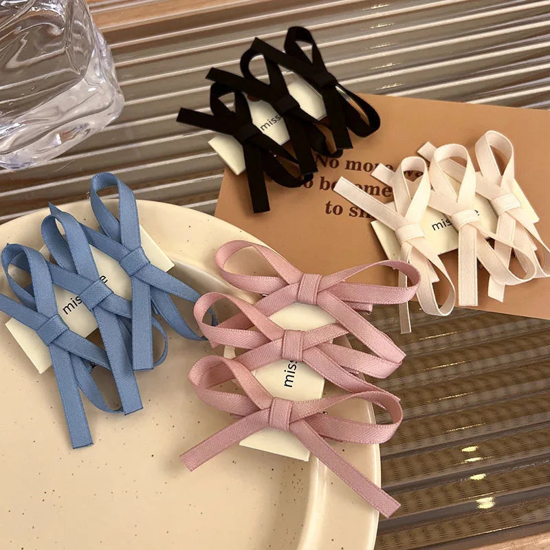 Set of colorful hair ties on a beige surface with a blurred background
