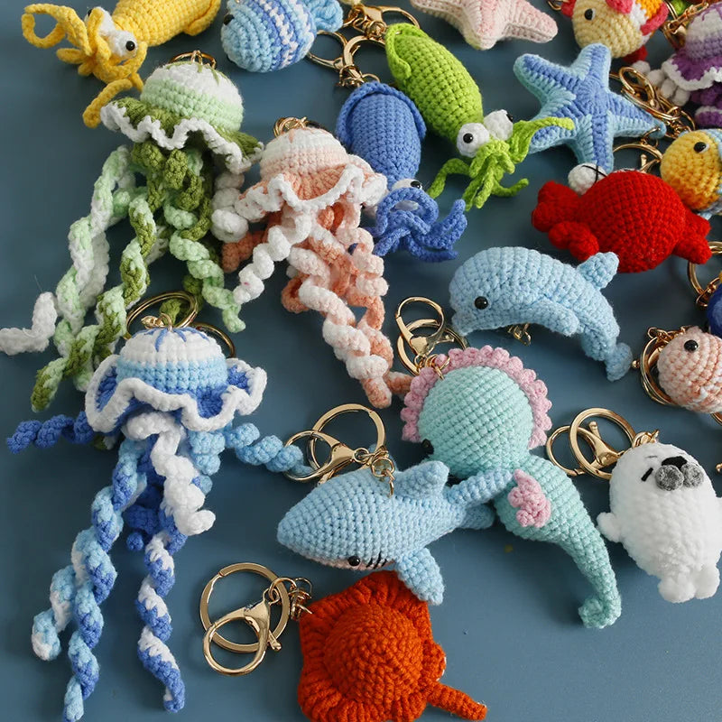 Collection of colorful crochet keychains on a blue background