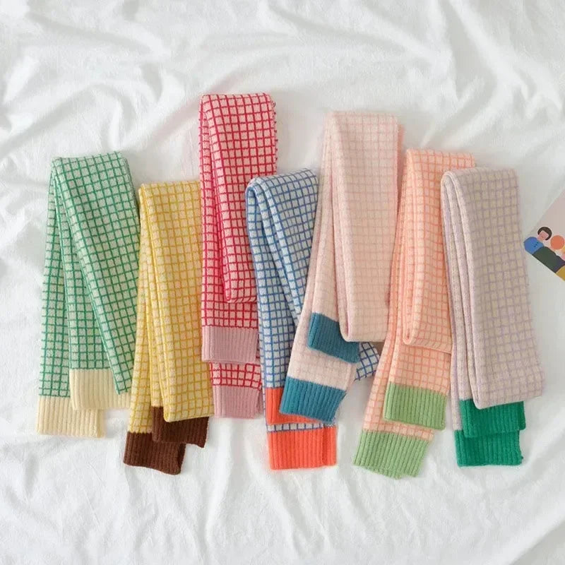 Colorful checkered skinny scartves on a white background