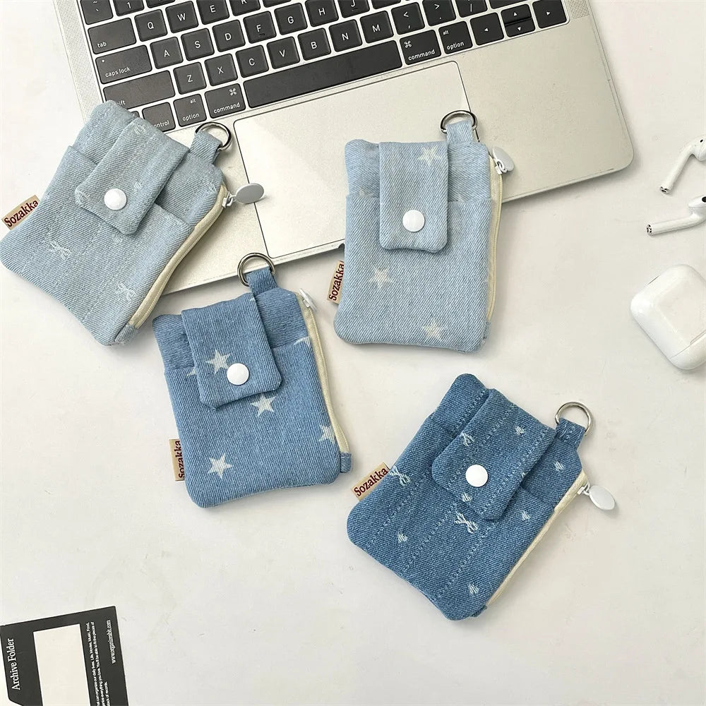 Set of blue fabric pouches with star patterns on a desk with a laptop and airpods.