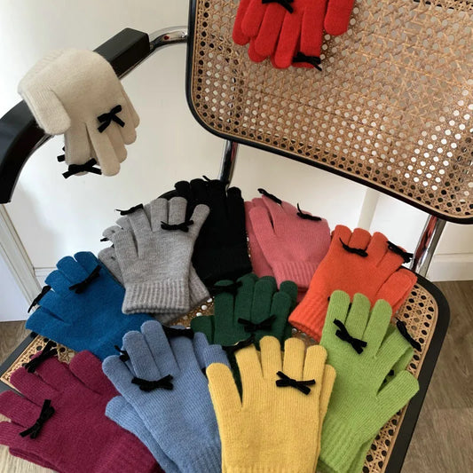 Colorful gloves with bow details on a chair
