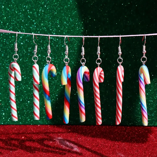 Candy cane-shaped earrings on a green and red glittery background