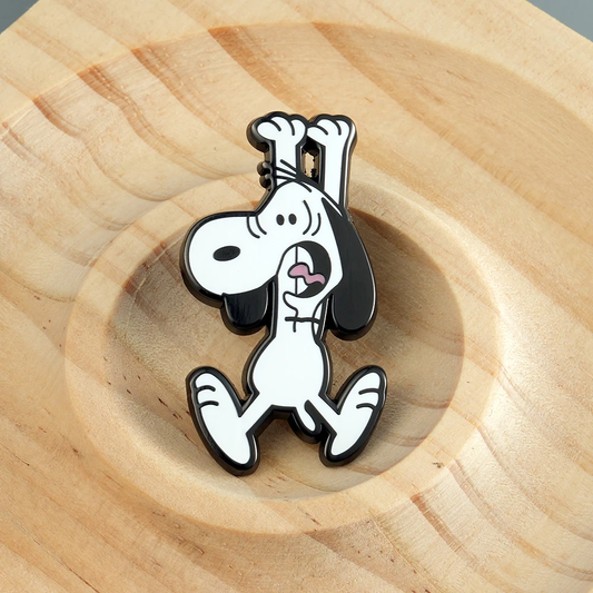 Snoopy pin on a wooden surface