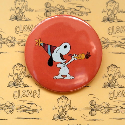 A vintage style pin button badge featuring Snoopy the beagle from the Peanuts comics celebrating a birthday