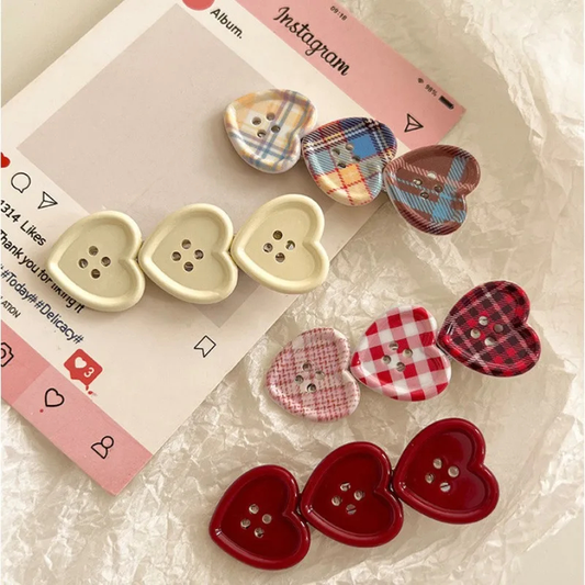 Heart-shaped button hair clips in various patterns on a textured surface with an Instagram album mockup.