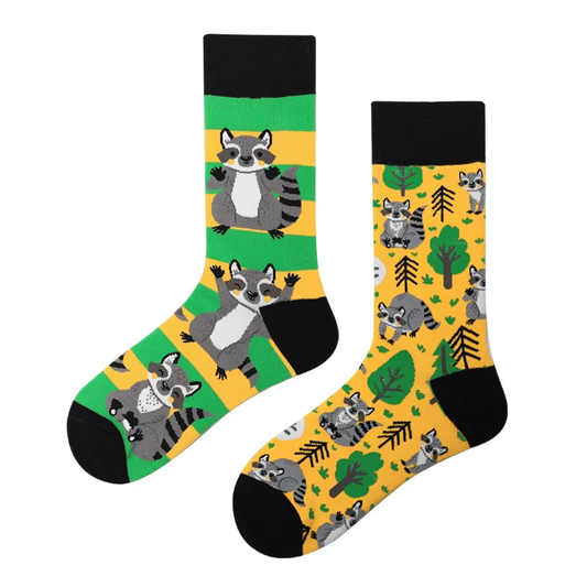 Two socks with raccoon and nature pattern on a white background
