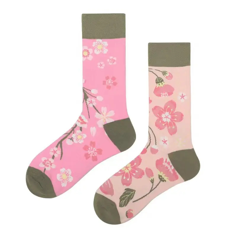 Pair of pink socks with floral design on a white background