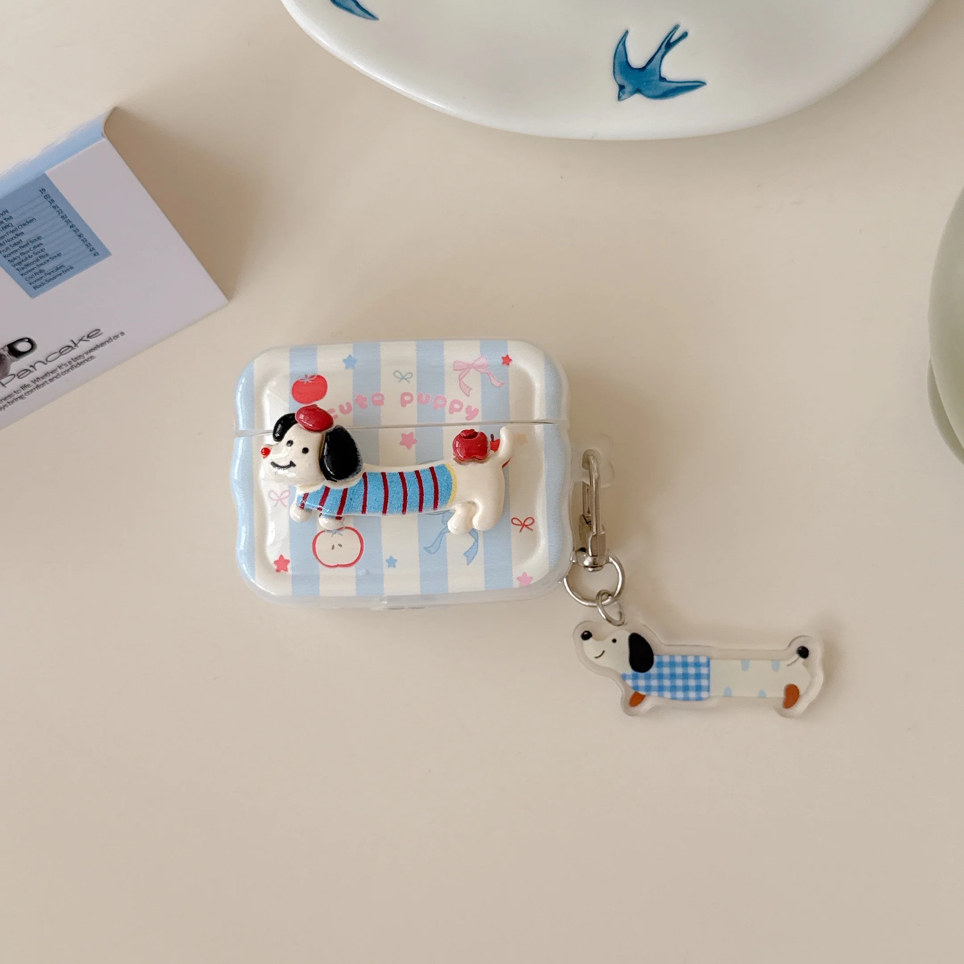 Cartoon dog character keychain and pouch on a light surface