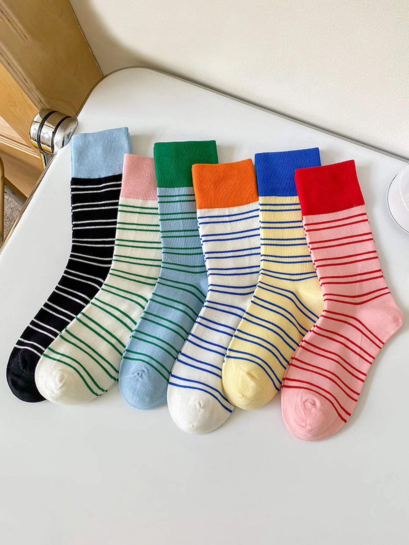 Set of colorful striped socks on a white surface