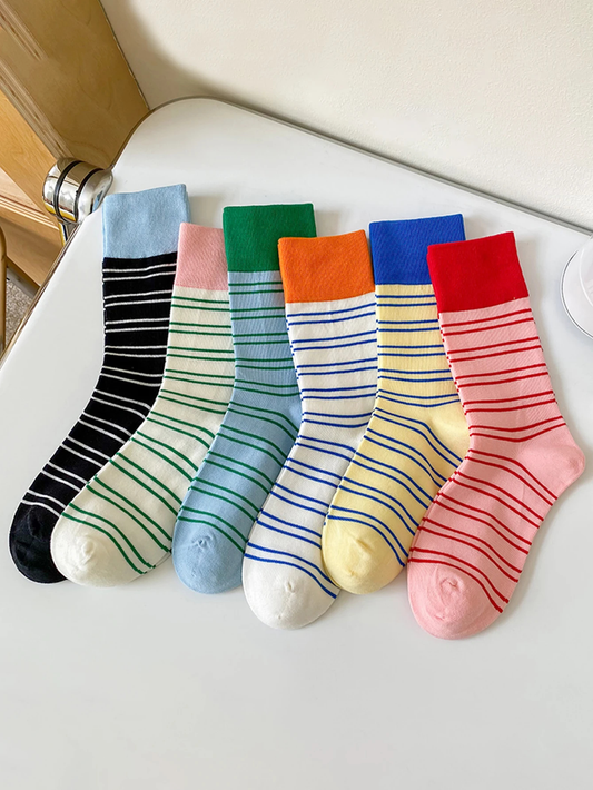 Set of colorful striped socks on a white surface