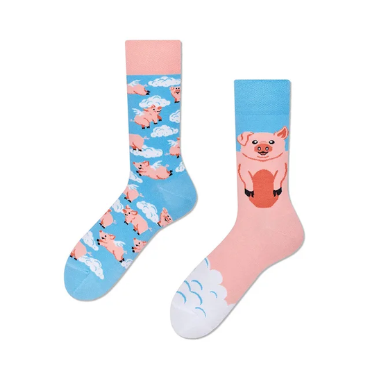 A pair of crew socks with a colorful animal pattern featuring pink pigs with blue and white cloud accents.