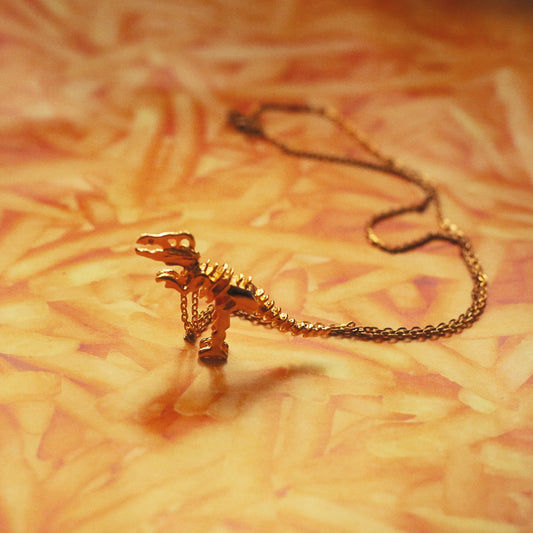 Gold T-rex dinosaur skeleton necklace - Ice Cream Cake