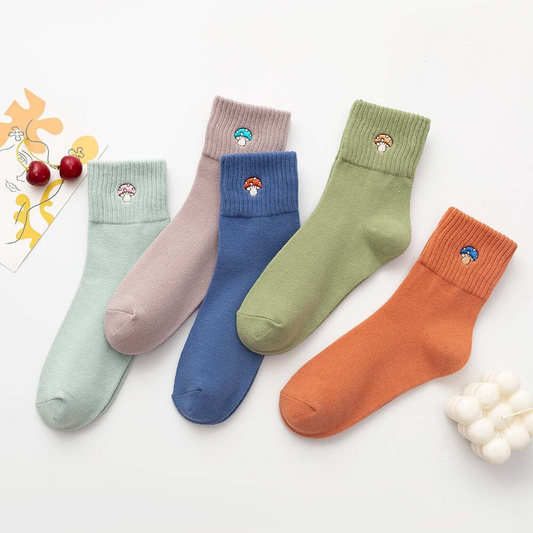 A set of five pairs of crew socks in various colors, each featuring a small embroidered mushroom design on the ankle area.